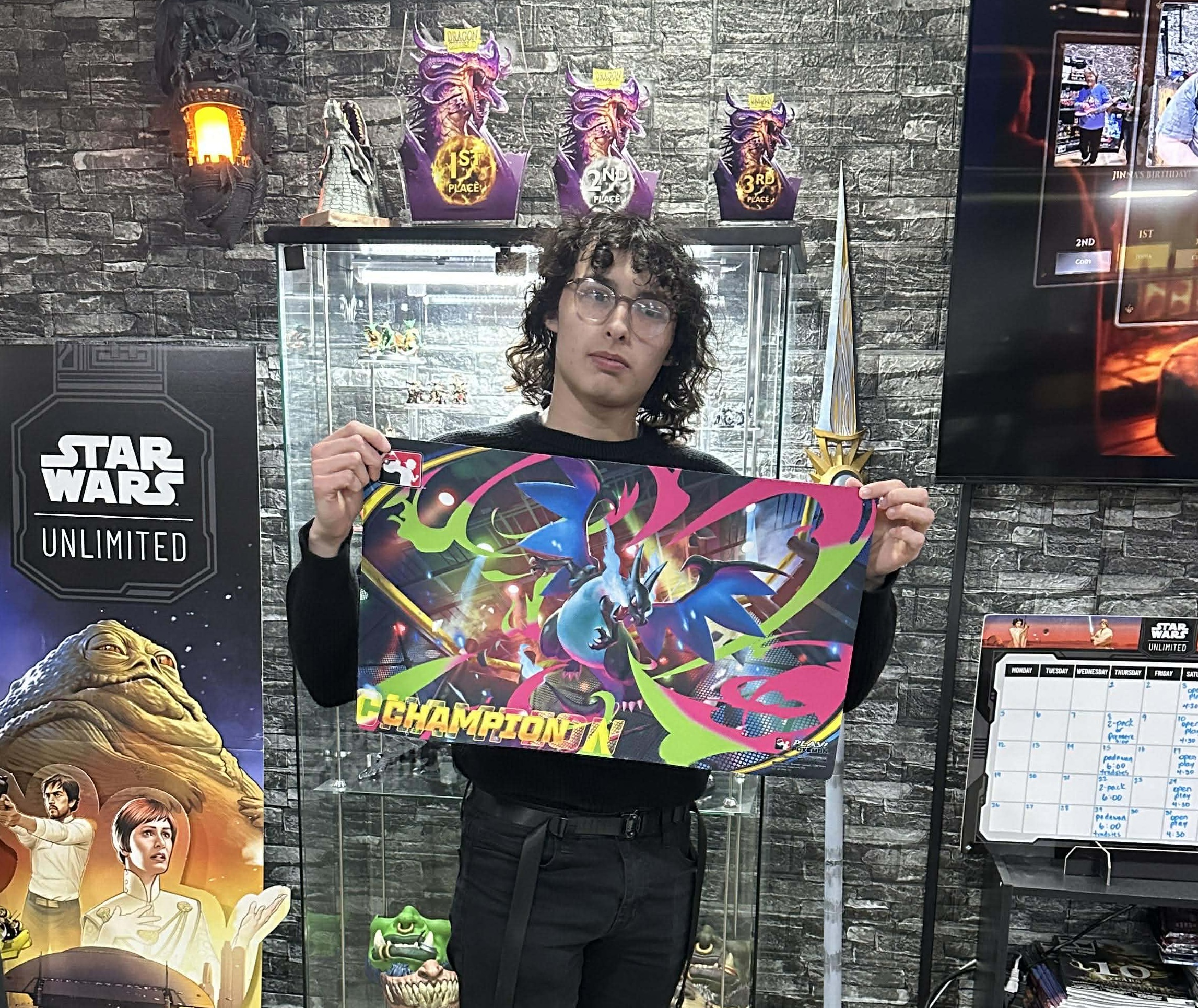 Blaine Wilson holding champ mat