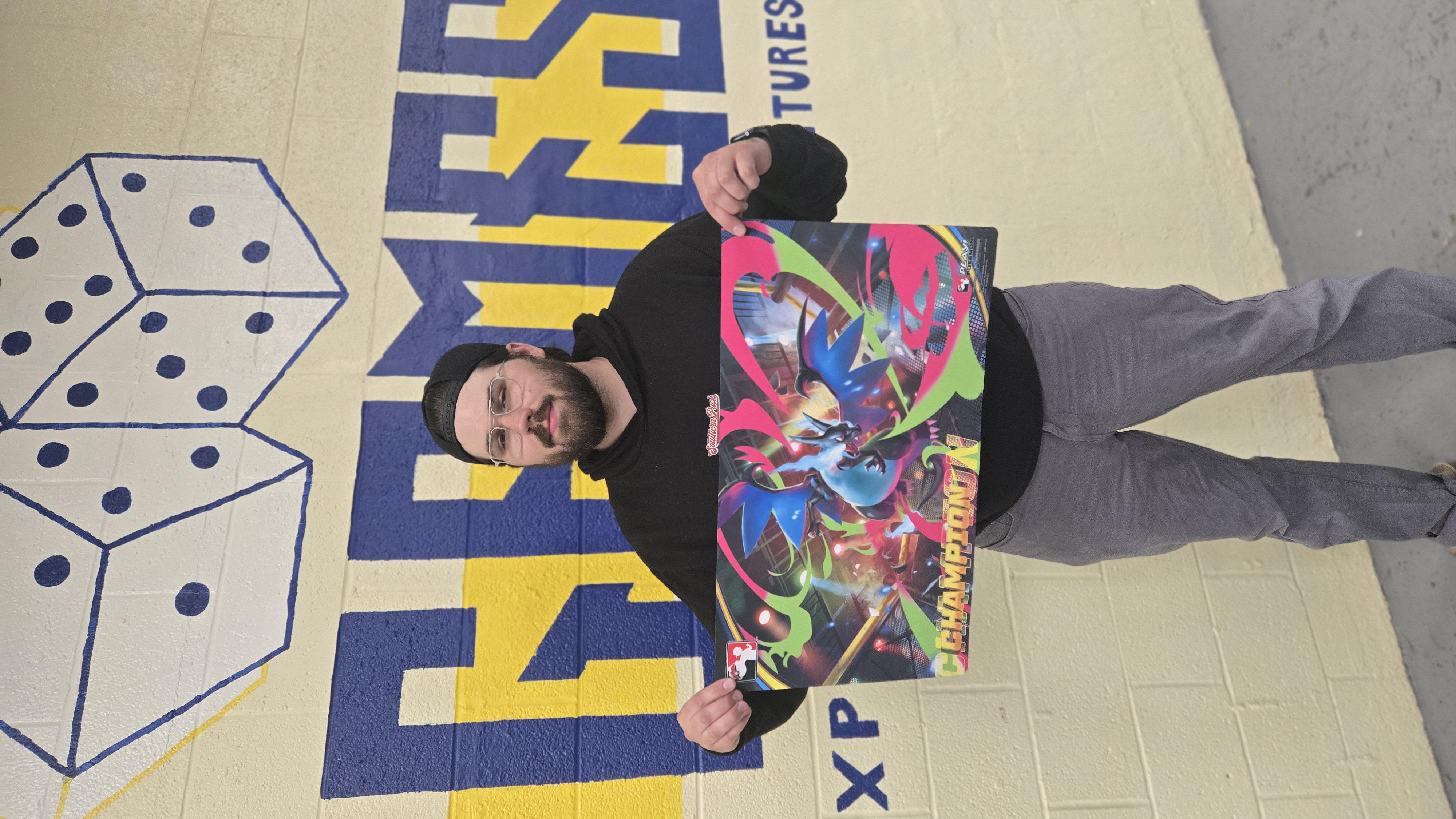 Aaron West holding his champ Mat