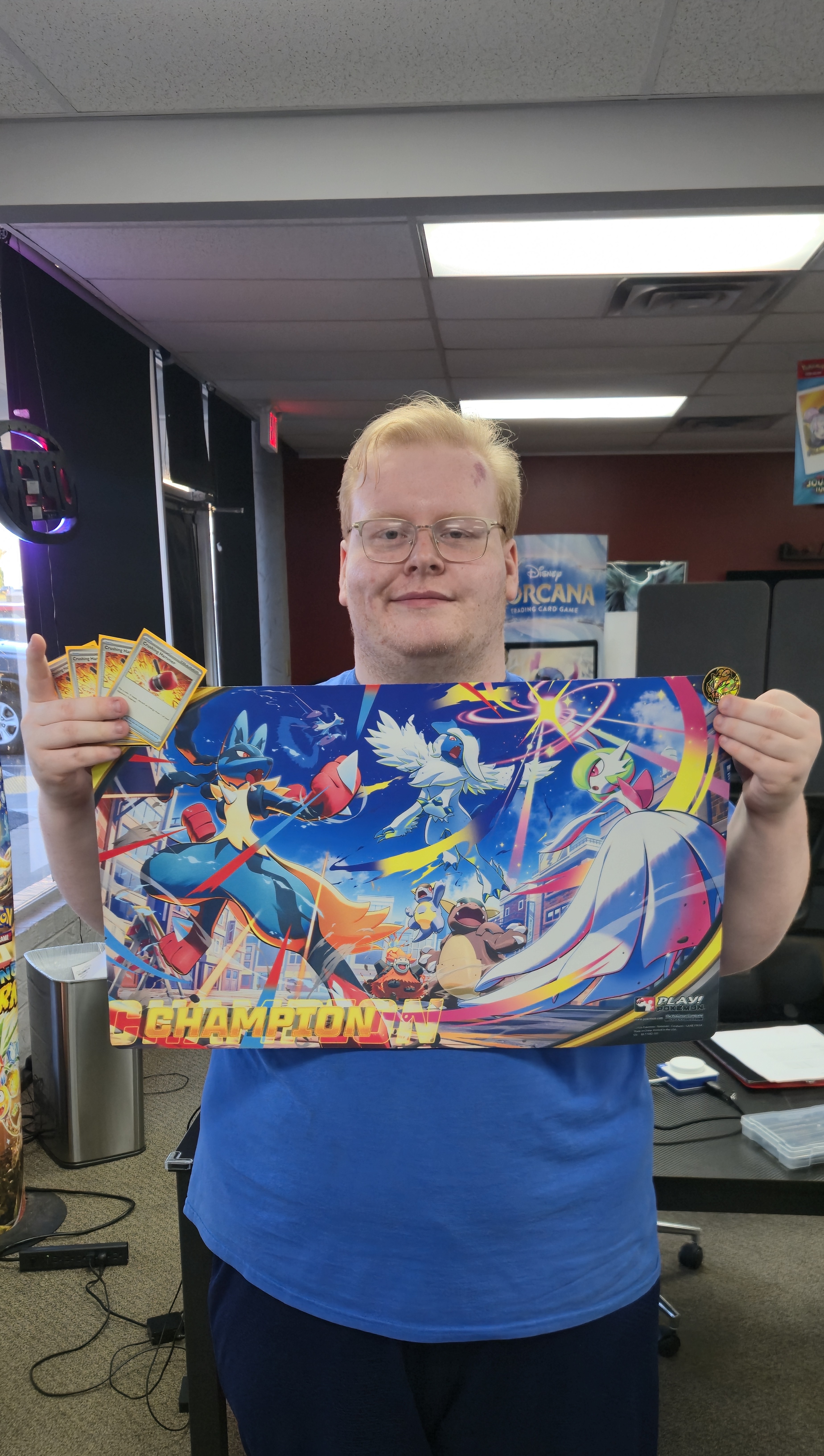Nate Kirksey holding champ mat