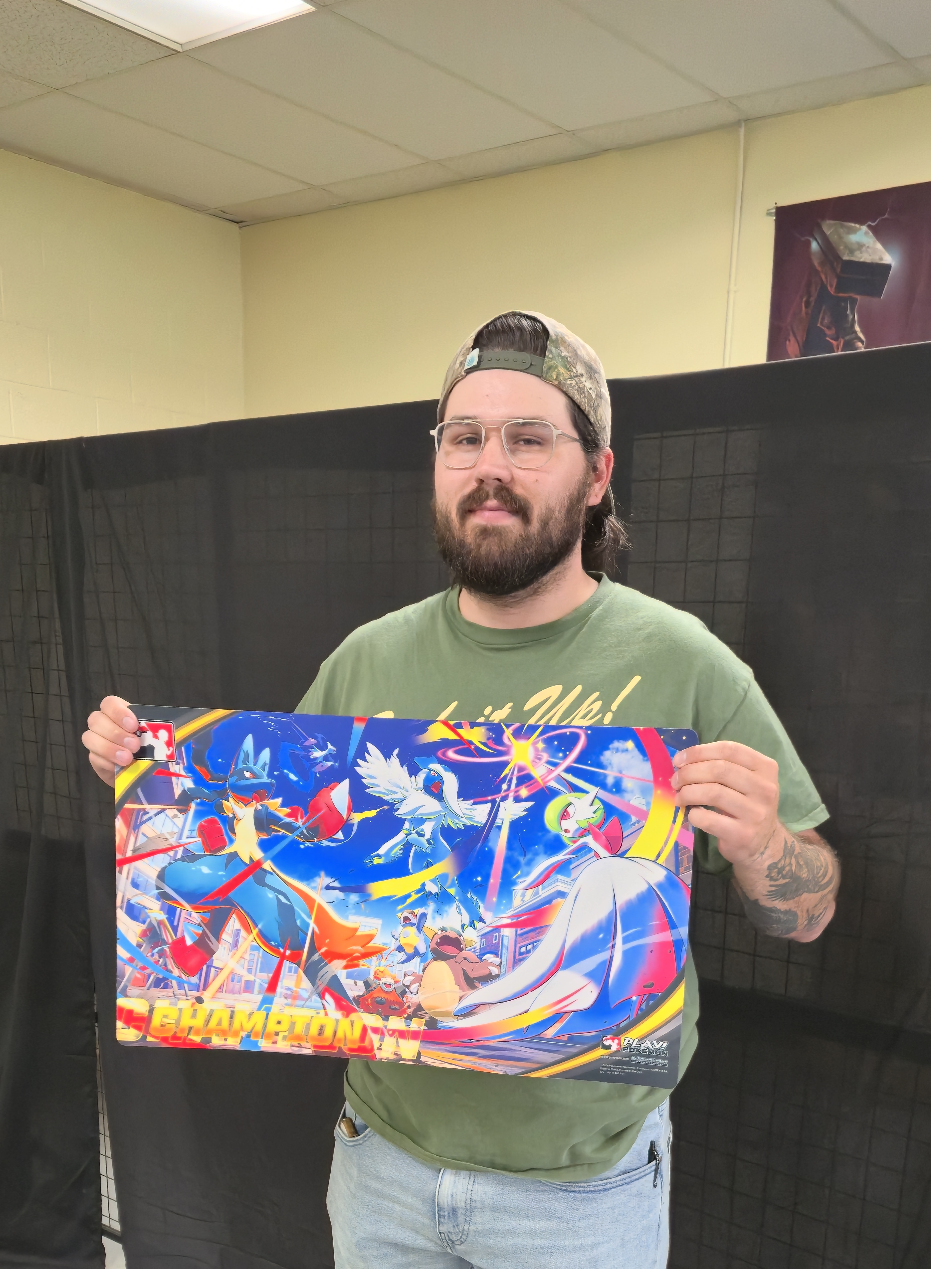 Aaron West holding champ mat